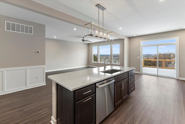 kitchen featuring open floor plan, a sink, dishwasher, and an island with sink