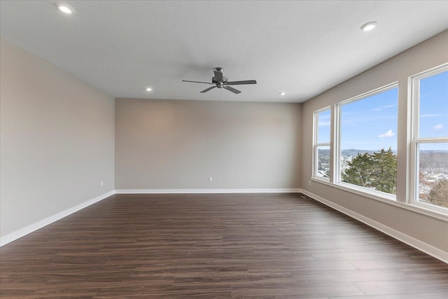 unfurnished room featuring ceiling fan, baseboards, dark wood-type flooring, and recessed lighting