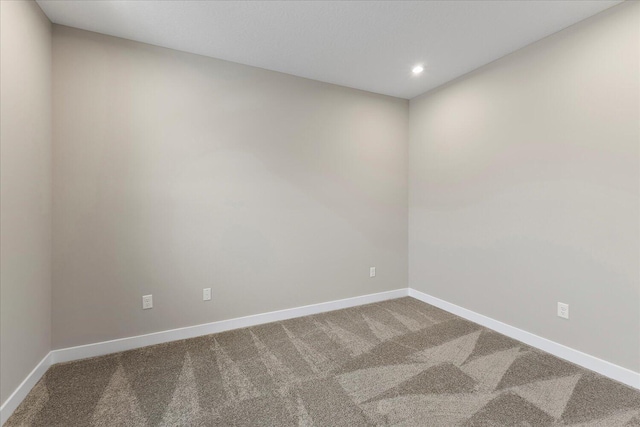 spare room featuring carpet, baseboards, and recessed lighting