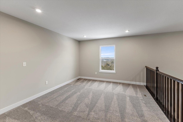 unfurnished room with carpet, baseboards, and recessed lighting