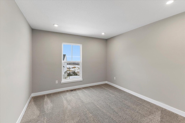 spare room with recessed lighting, carpet flooring, and baseboards