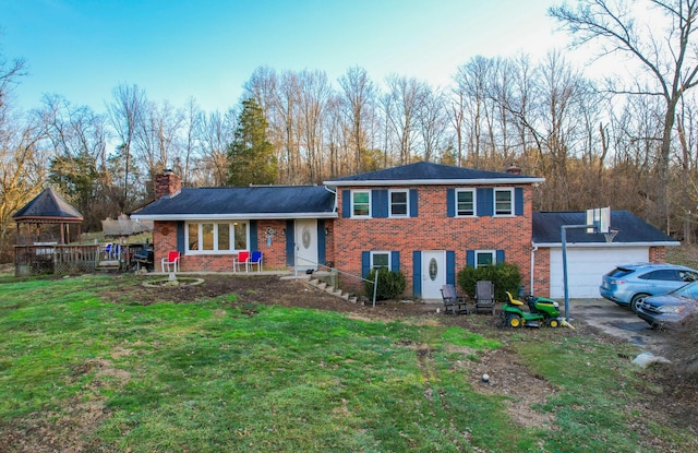 view of front of property featuring a garage and a front yard