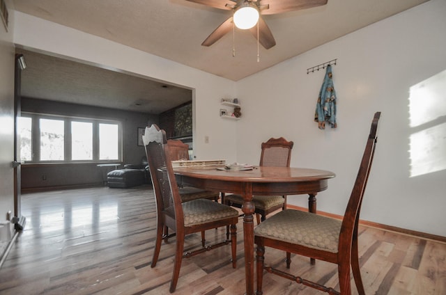 dining space with light hardwood / wood-style flooring and ceiling fan