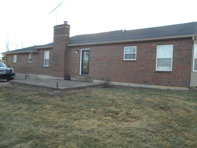 rear view of house featuring a patio and a lawn