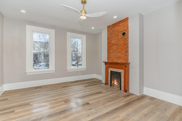 unfurnished living room with light hardwood / wood-style flooring and a fireplace