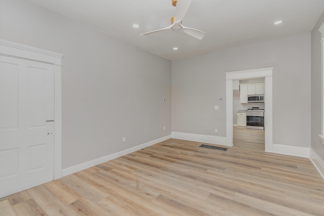 empty room featuring ceiling fan and light wood-type flooring