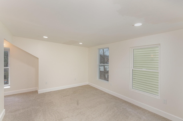 unfurnished room featuring light colored carpet