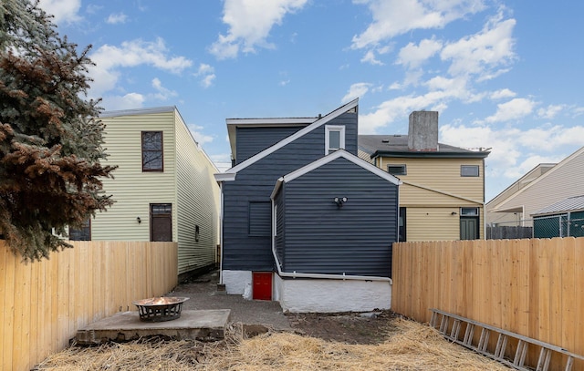 rear view of house featuring a fire pit