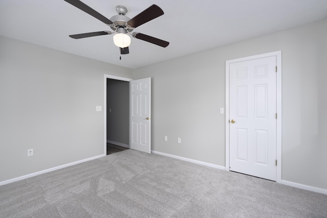 unfurnished bedroom with ceiling fan and light colored carpet