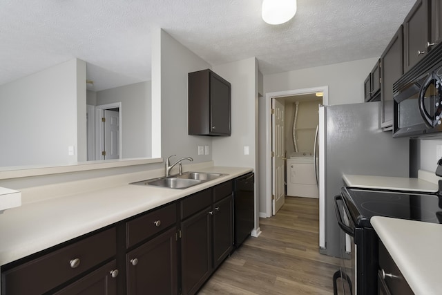 kitchen featuring sink, a textured ceiling, dark brown cabinets, hardwood / wood-style floors, and black appliances