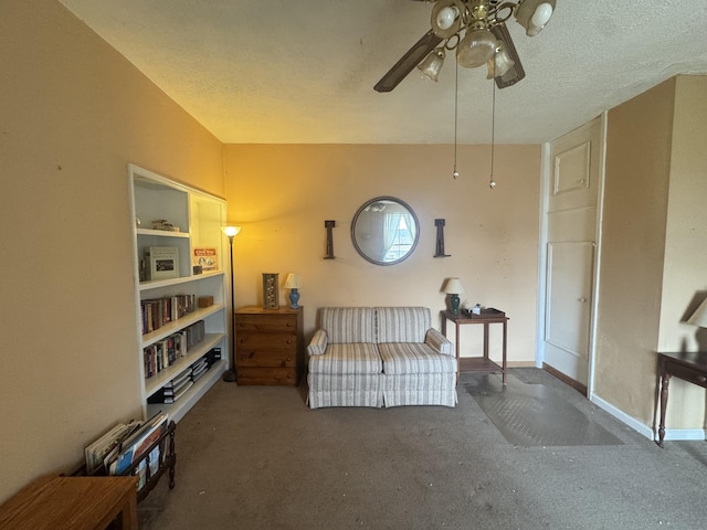 living area with dark colored carpet, vaulted ceiling, ceiling fan, and a textured ceiling