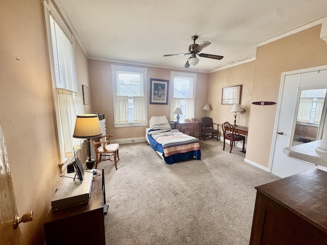 carpeted bedroom featuring crown molding and ceiling fan