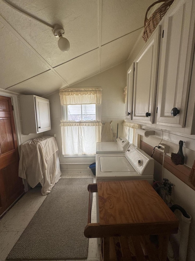 laundry room featuring cabinets and washer and clothes dryer