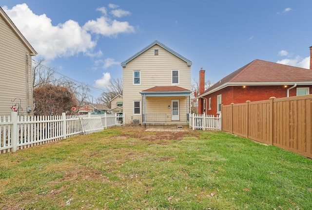 back of house with a lawn