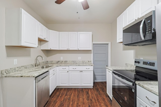 kitchen with sink, dark hardwood / wood-style flooring, ceiling fan, stainless steel appliances, and white cabinets