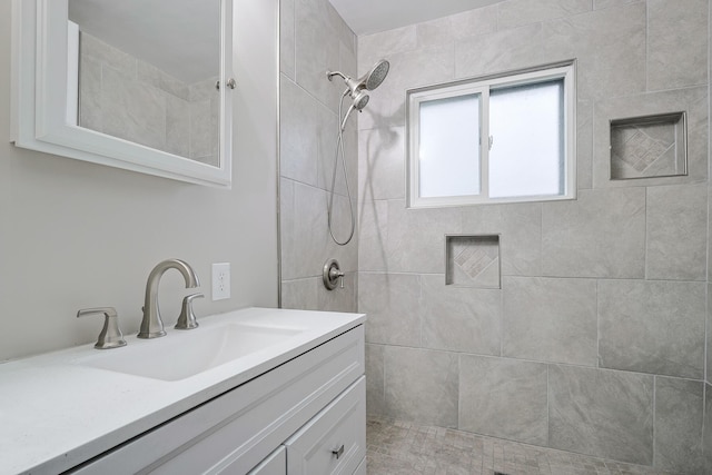 bathroom with vanity and tiled shower