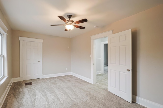 carpeted empty room with ceiling fan