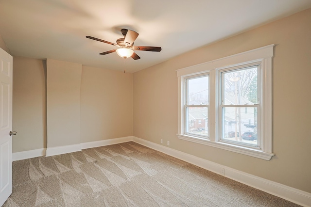 unfurnished room featuring ceiling fan and carpet flooring