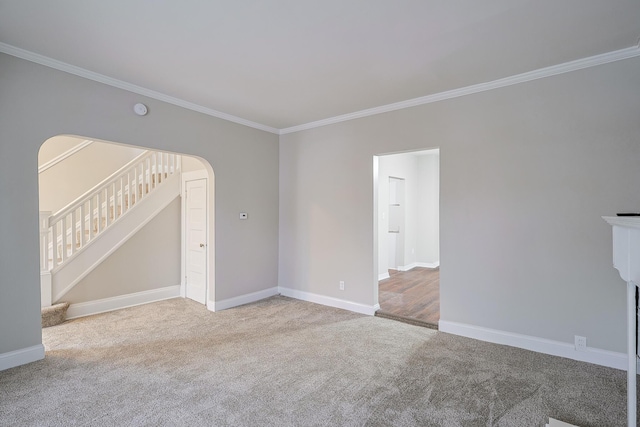 unfurnished living room featuring ornamental molding and light carpet