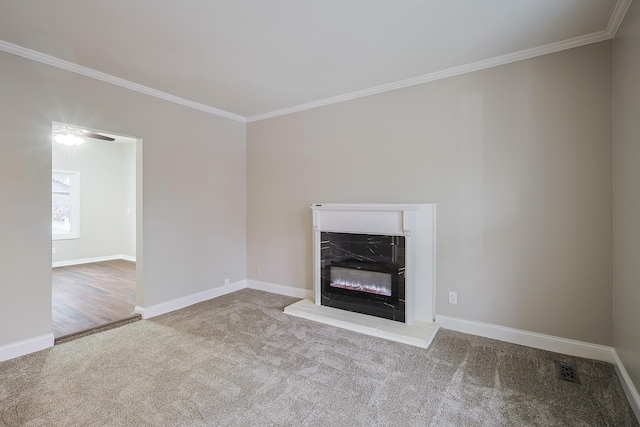 unfurnished living room with ornamental molding, a fireplace, and light colored carpet