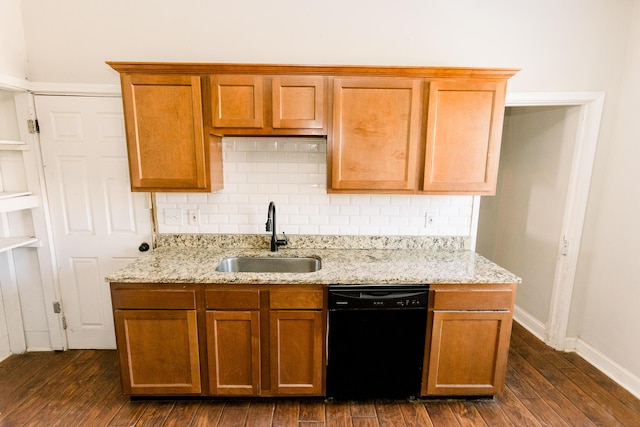 kitchen with dark hardwood / wood-style flooring, dishwasher, sink, and light stone countertops