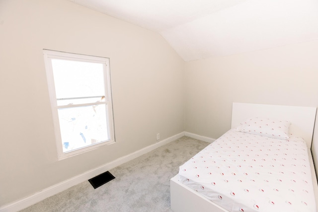 carpeted bedroom featuring lofted ceiling