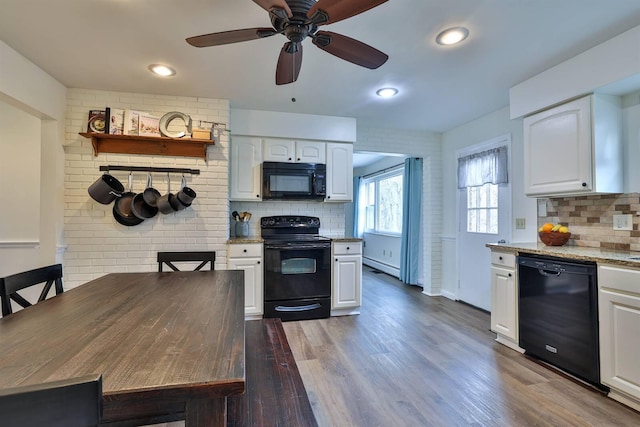 kitchen featuring white cabinets, decorative backsplash, black appliances, light stone countertops, and dark wood-type flooring