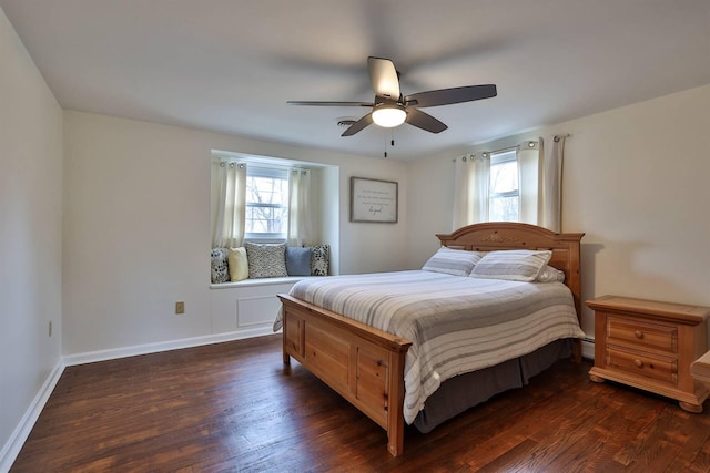 bedroom with multiple windows, dark wood-type flooring, and ceiling fan