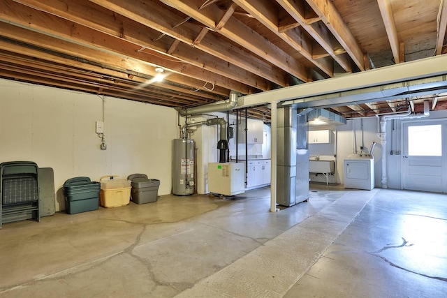 basement featuring sink, washer / dryer, and gas water heater