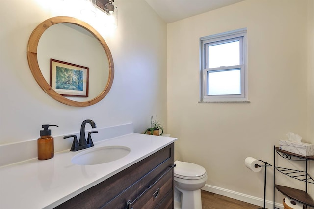 bathroom with vanity, wood-type flooring, and toilet