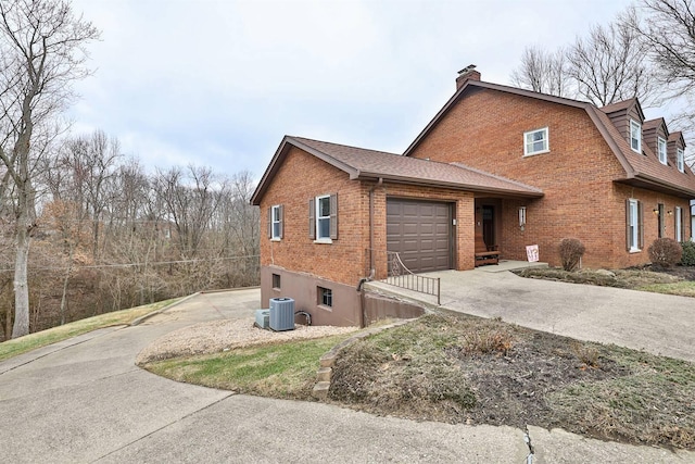 view of side of property featuring a garage and central AC unit