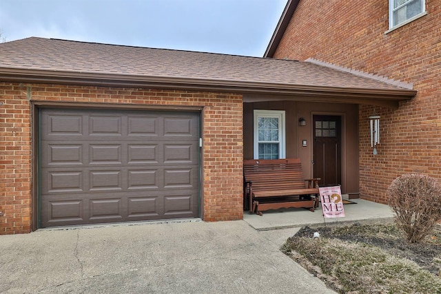 doorway to property with a garage