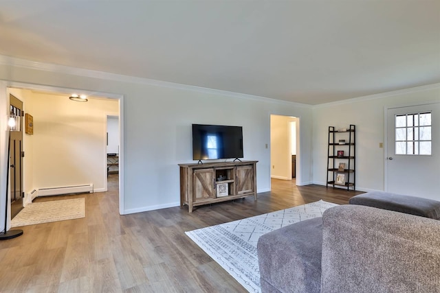 living room with crown molding, hardwood / wood-style floors, and baseboard heating