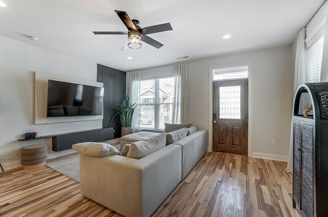 living room featuring light hardwood / wood-style flooring, plenty of natural light, and ceiling fan