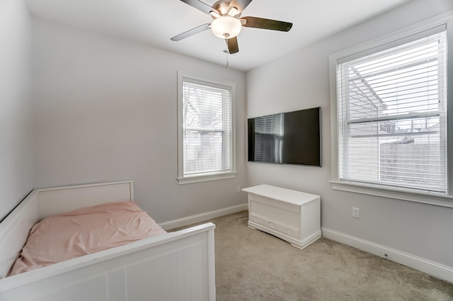 bedroom featuring ceiling fan and light carpet