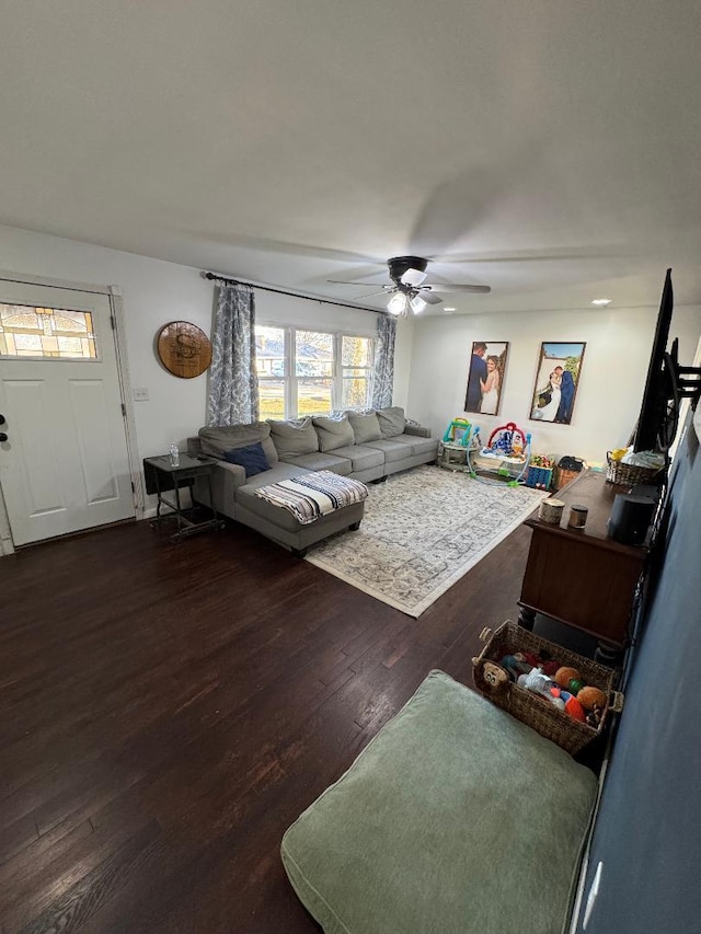 living room with ceiling fan and dark hardwood / wood-style floors