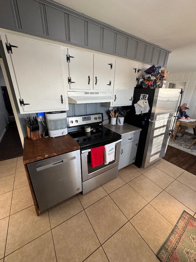 kitchen with white cabinetry, appliances with stainless steel finishes, and light tile patterned floors