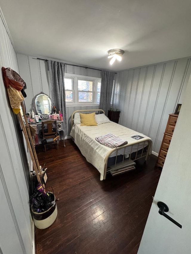 bedroom with dark hardwood / wood-style floors