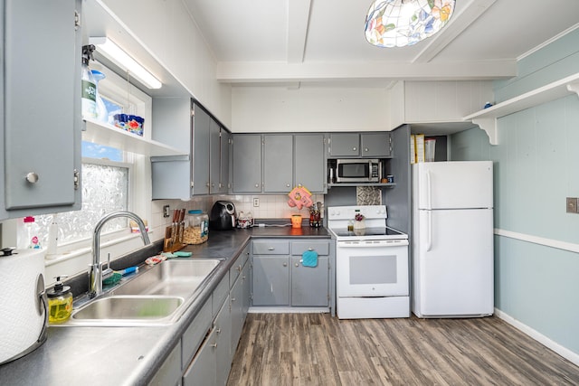 kitchen with dark hardwood / wood-style floors, sink, white appliances, and gray cabinets