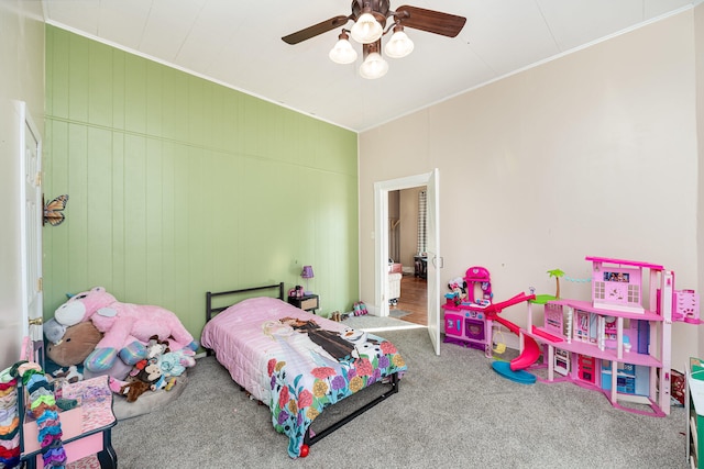 bedroom with ornamental molding, ceiling fan, and carpet