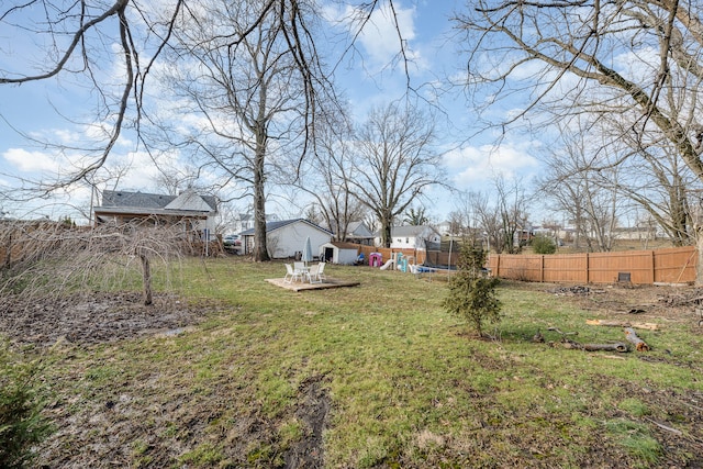 view of yard with a trampoline and a playground