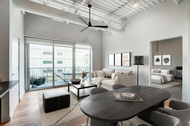 120 Main St Unit 313, Newport, KY 41071 - living area featuring light wood-style flooring, a towering ceiling, and a ceiling fan