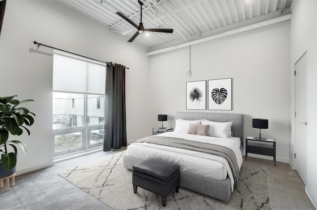 bedroom with a ceiling fan and baseboards