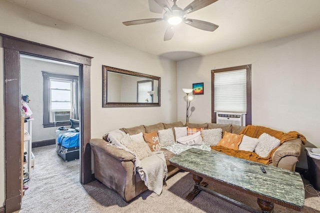 living room featuring light colored carpet, ceiling fan, and cooling unit