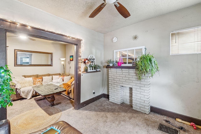 interior space featuring ceiling fan, a fireplace, and a textured ceiling