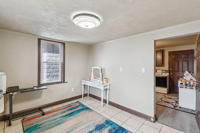 rec room with ornamental molding, a textured ceiling, and light tile patterned flooring