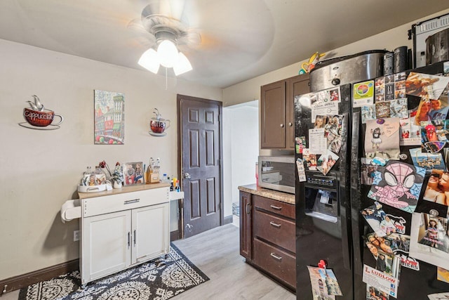 kitchen featuring dark brown cabinetry, black fridge with ice dispenser, light hardwood / wood-style flooring, and ceiling fan