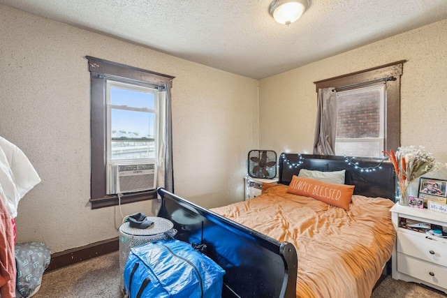 carpeted bedroom featuring cooling unit and a textured ceiling