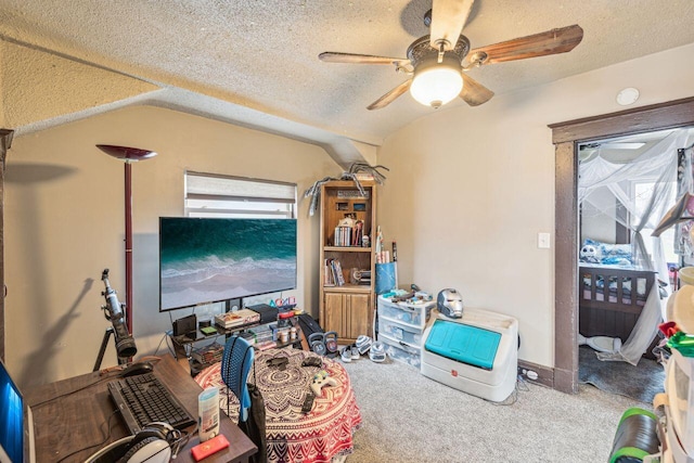 interior space with vaulted ceiling, ceiling fan, and a textured ceiling