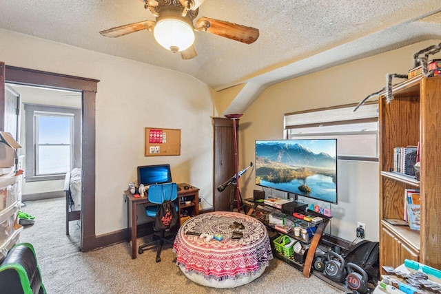 recreation room featuring ceiling fan, carpet, and a textured ceiling